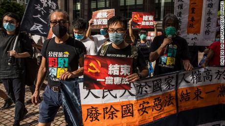 Pro-democracy prostesters march during a rally against a new national security law in Hong Kong on July 1, 2020, on the 23rd anniversary of the city&#39;s handover from Britain to China. - China imposed a sweeping national security law on Hong Kong on June 30, a historic move that critics and many western governments fear will smother the finance hub&#39;s freedoms and hollow out its autonomy. (Photo by DALE DE LA REY / AFP) (Photo by DALE DE LA REY/AFP via Getty Images)